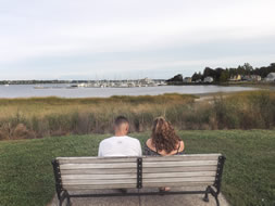 Guy and girl sitting on park bench