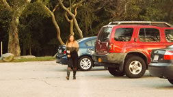 Girl walking in a parking lot