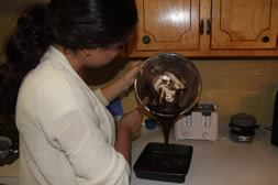 Girl pouring brownie batter