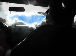 Guy blowing out blue smoke